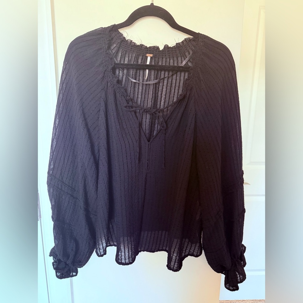 Free people black blouse with tie front and beautiful details.